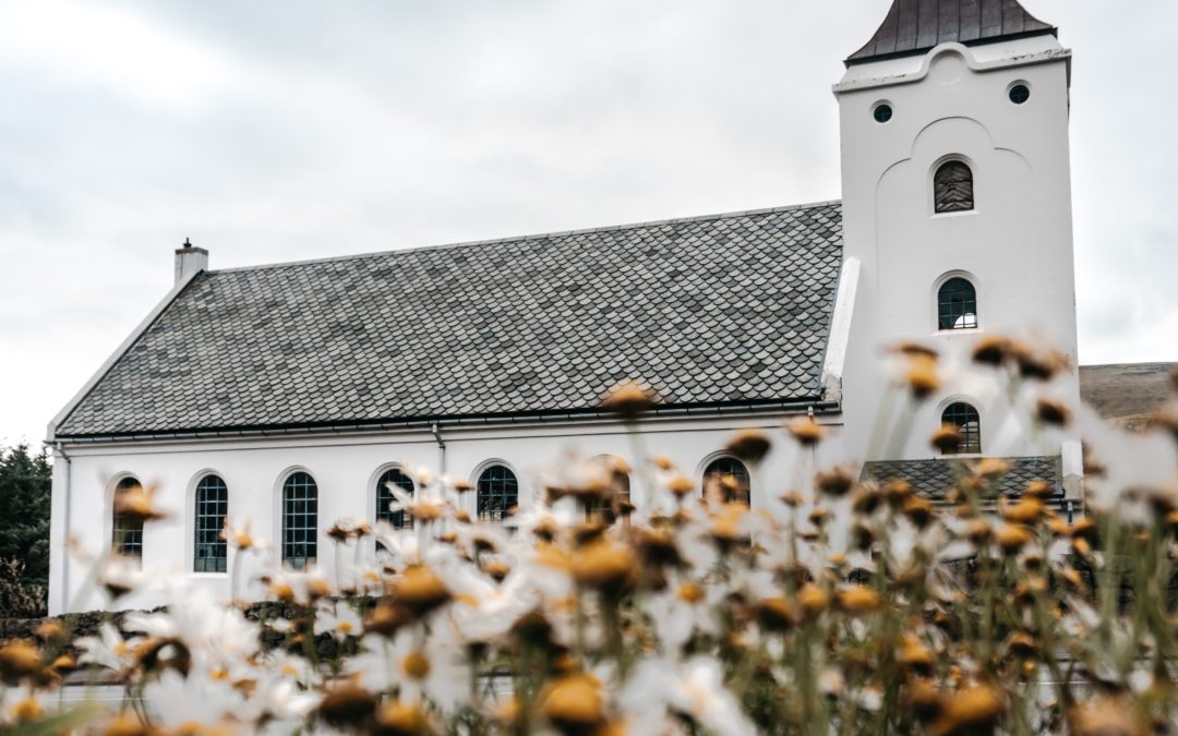 church with flowers in foreground